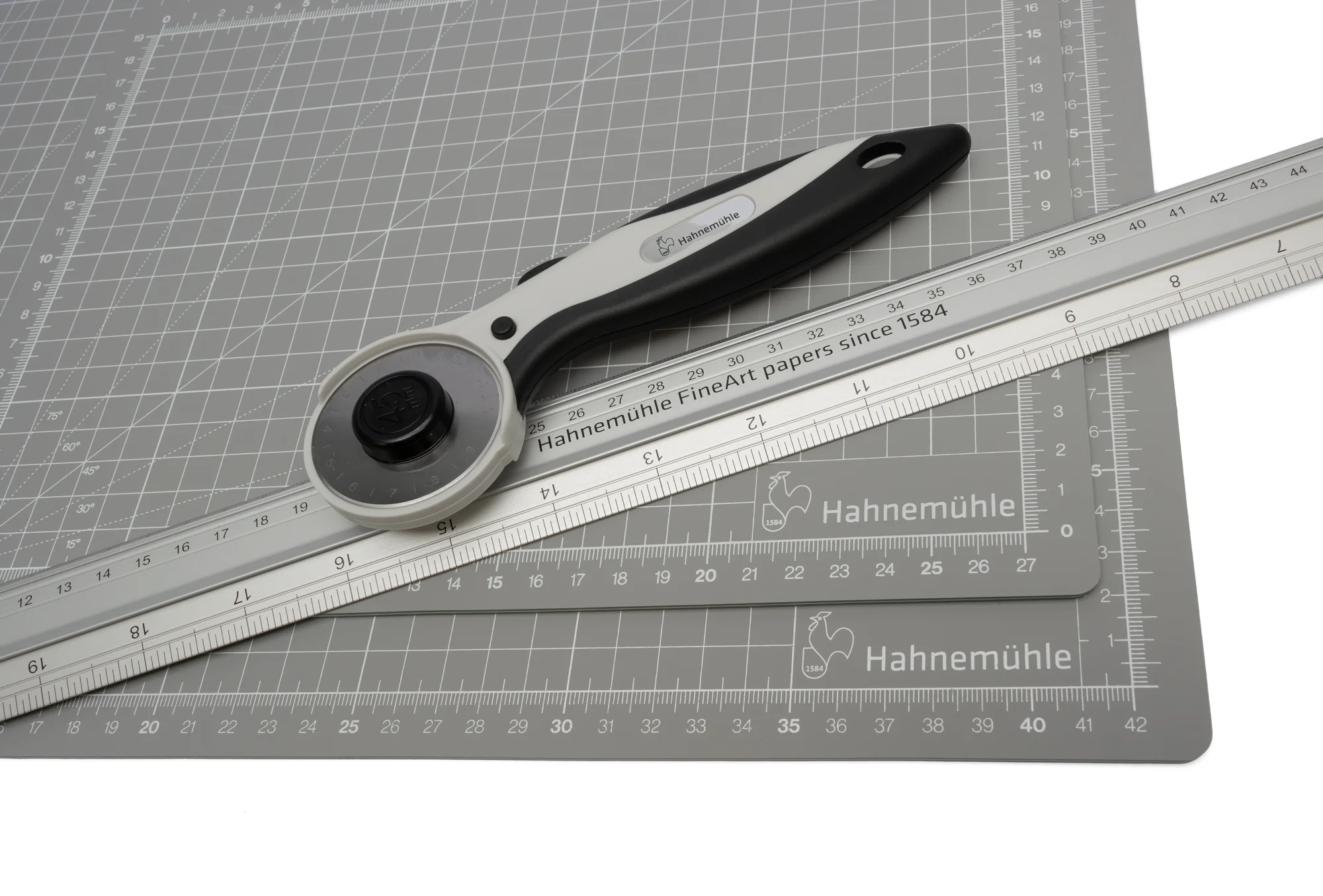 rotary cutter, steel ruler, grid mat, crafting tool, adjustable blade