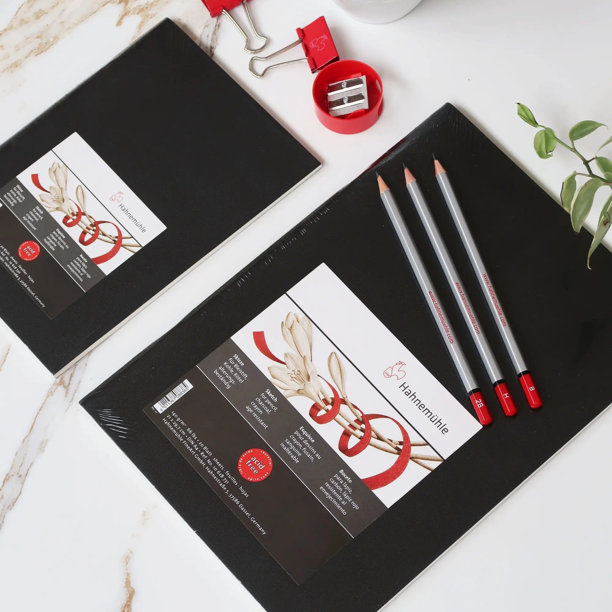 notebook, black notebook, pencils, craft supplies, red accents