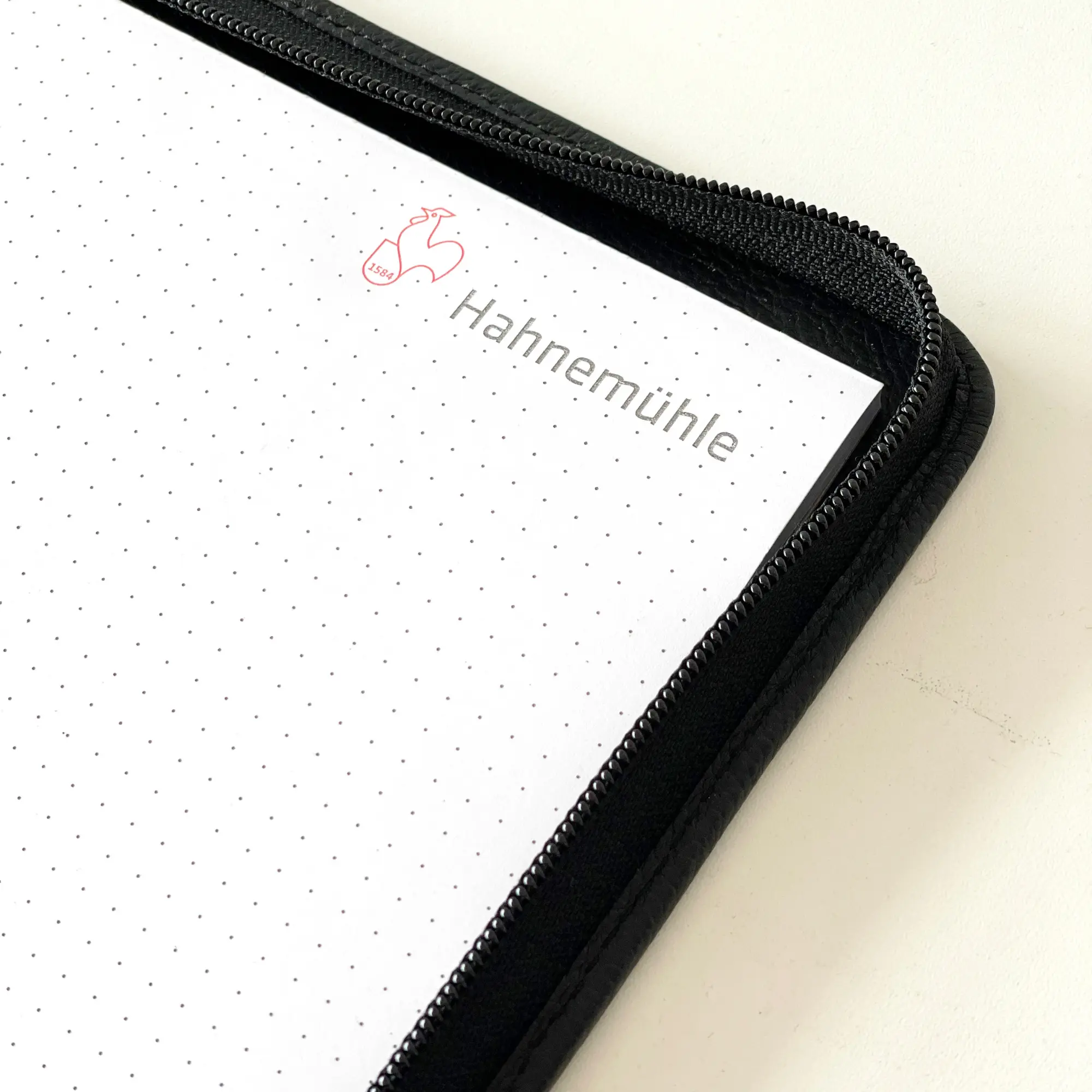 notebook, dot grid, zippered, black, brand visible